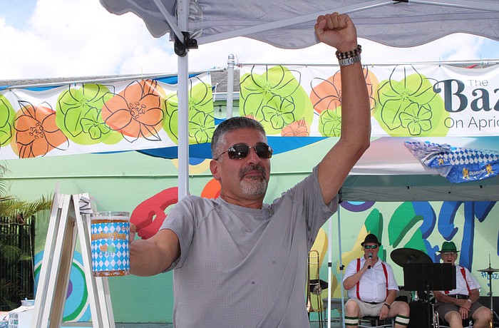 Anthony Baffo celebrates his win in the stein-holding competition at The Bazaar on Apricot & Lime's inaugural Oktoberfest on Oct. 4.