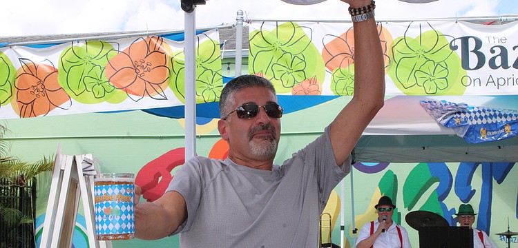 Anthony Baffo celebrates his win in the stein-holding competition at The Bazaar on Apricot & Lime's inaugural Oktoberfest on Oct. 4.