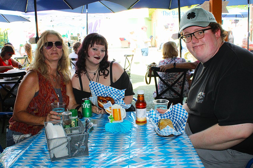 Ellen, Cameron and Jackson McCann sample the giant pretzel and apple strudel freshly prepared by Chef Mitch Rosenbaum at The Bazaar on Apricot & Lime's Oktoberfest.