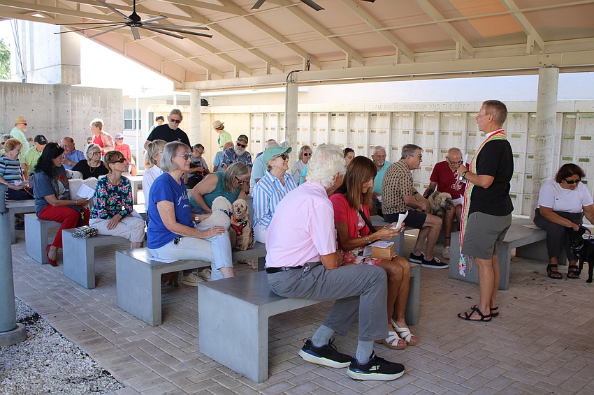 Puppy faces peak out in the crowd of attendees of a special Oct. 4 pet blessing service led by Rev. Nikki Seger.