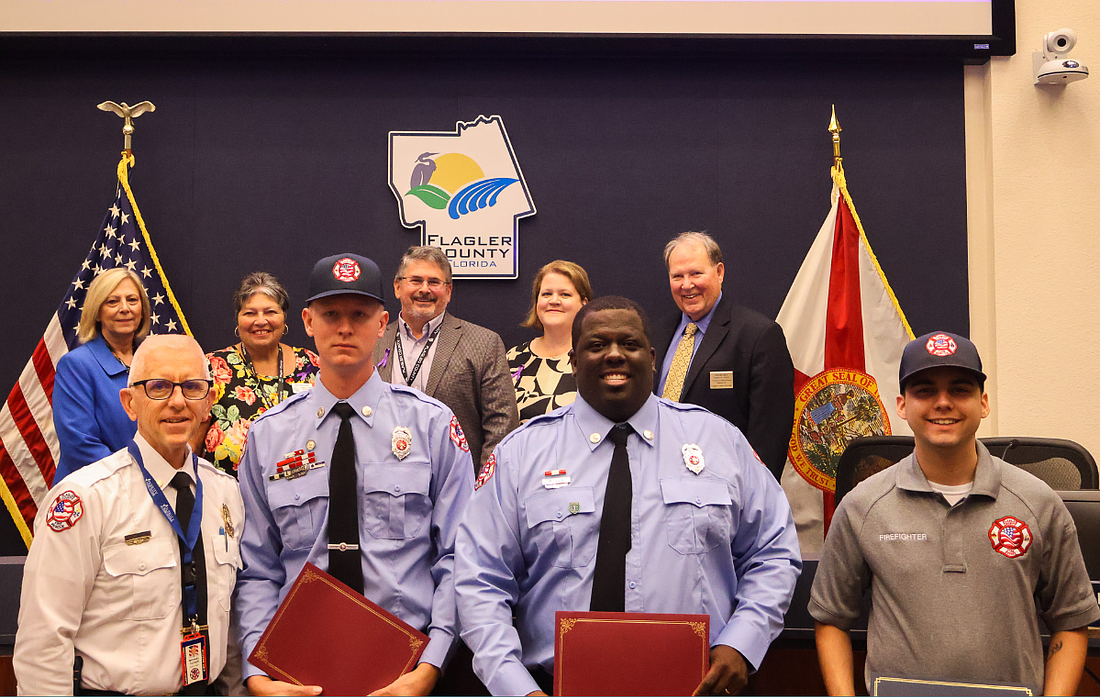 Fire Chief Mike Tucker presented Life Saving Awards to Rescue Supervisor Beau Kruithoff, Firefighter/Paramedic Marcus Ellis and Paramedic Sebastian Eichenlaub-Bowden. Rescue Supervisor Tyler Allesee also received the award, but was absent from the meeting. Courtesy Flagler County
