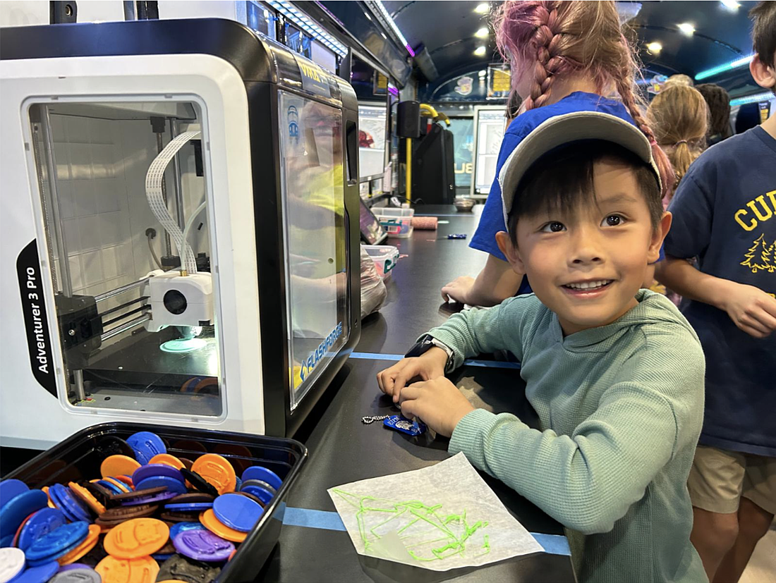 Six-year-old student Pierre Ignacio proudly shows off a 3D-printed STEM keychain he designed and created inside the Volusia County School Stem Bus. Courtesy photo
