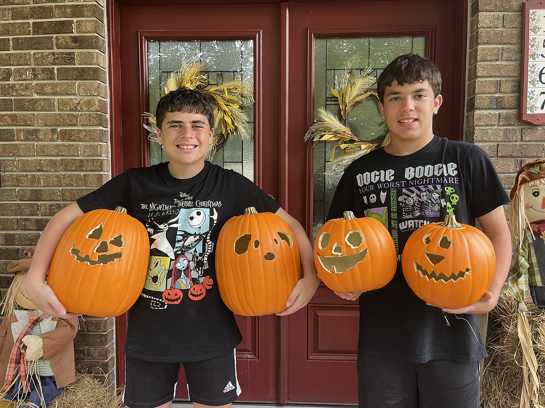 Winter Garden’s Diego Abreu and his brother, Colton Abreu, are ready for Pumpkin Glow with their newly carved pumpkins and their pumpkins from last year’s event.