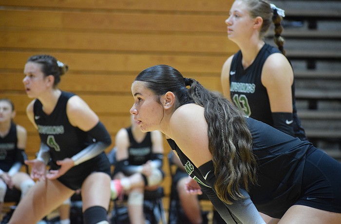 Kora Yanes (center) of Lakewood Ranch girls' volleyball gets into her stance before a point during an Oct. 9 match at Palmetto. The senior outside hitter/right setter has over 200 kills for the second straight year.