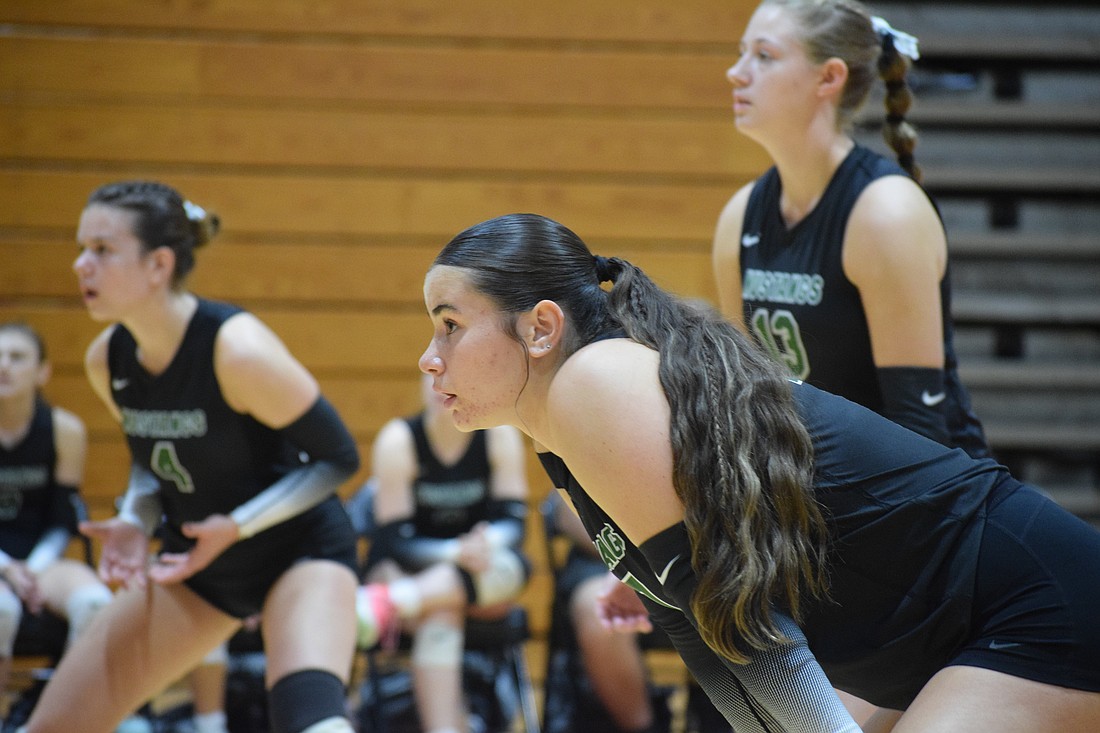 Kora Yanes (center) of Lakewood Ranch girls' volleyball gets into her stance before a point during an Oct. 9 match at Palmetto. The senior outside hitter/right setter has over 200 kills for the second straight year.