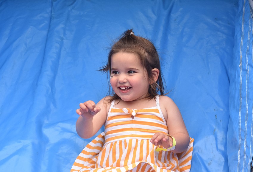 Lakewood Ranch's Josie Hillier, 2, slides down an inflatable slide at the Pumpkin Festival at Hunsader Farms on Oct. 11.
