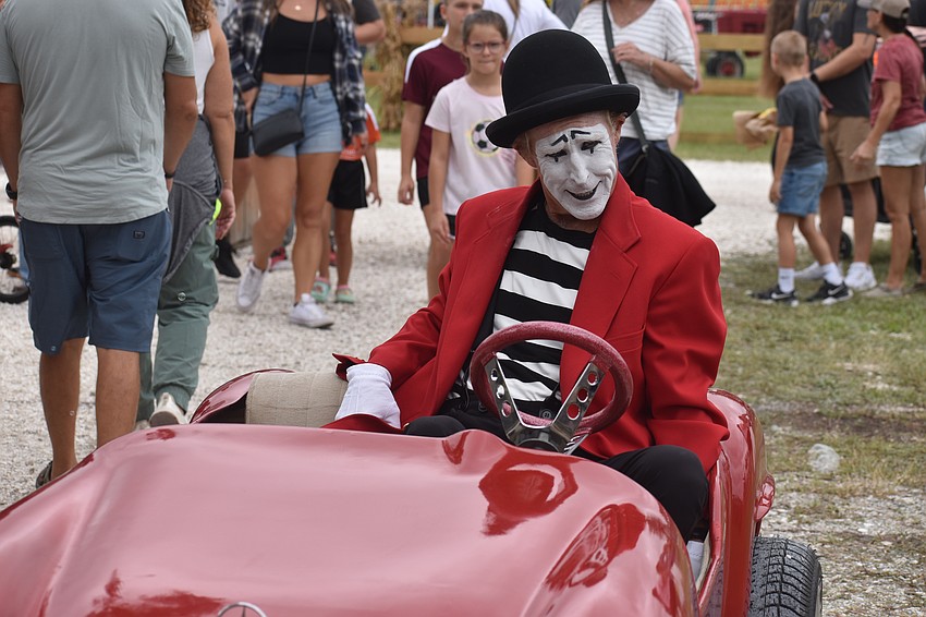 Lynn the Mime cruises around Hunsader Farms at the Pumpkin Festival on Oct. 11.