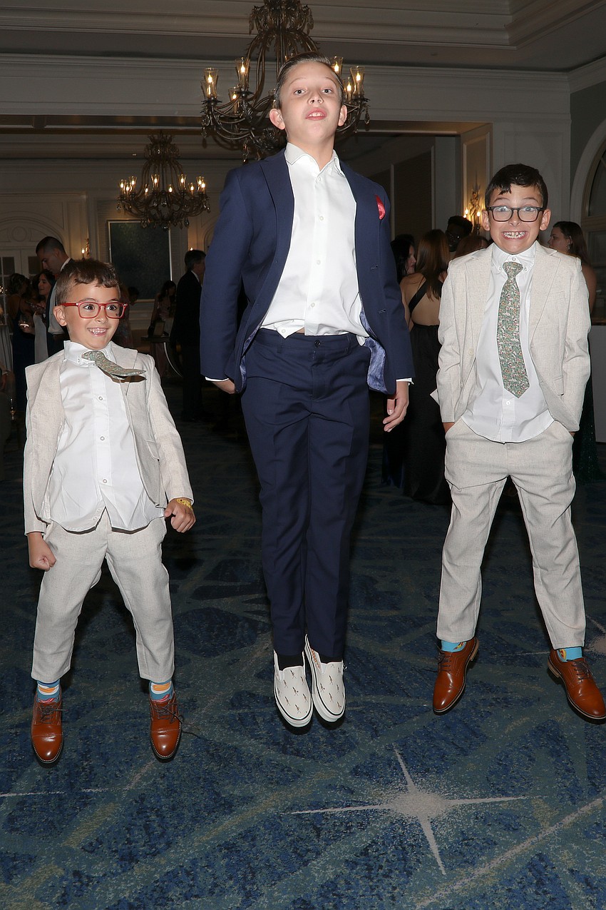 Noah Boorum, Charlie Guzman and Greyson Boorum keep busy during the Pearls & Prosecco cocktail hour.