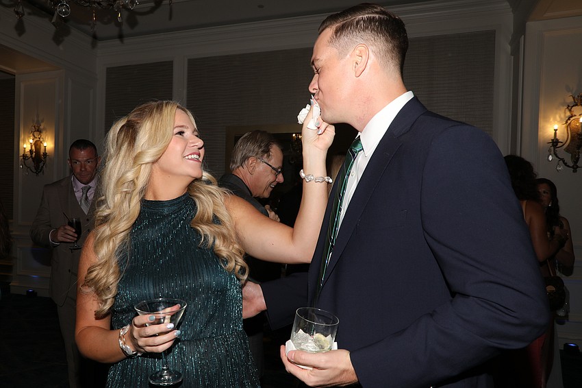 Kayla Winter takes care of a little smudge on husband Murrell's face.