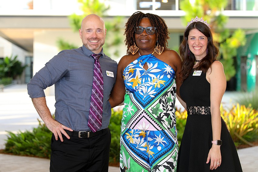 Chris Ostermeyer and Sarah Reno check guest Mary Butler (center) in for the Taste of New Orleans event on Oct. 11.