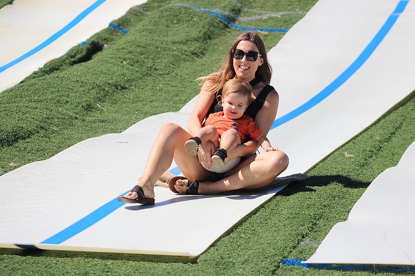 Scarlet Linn tries out the slide with her 18-month-old son, Rowan.