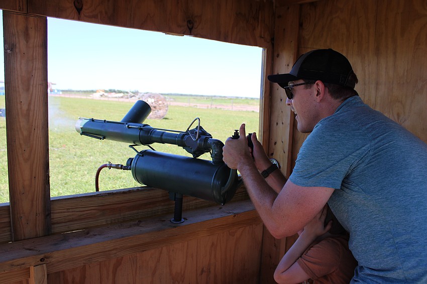 Safety Harbor 6-year-old Alden Kunzig covers his ears as his dad, Phil Kunzig, shoots the apple launcher during the Harvest Festival Oct. 12.
