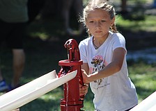 Lakewood Ranch's Jenna Ziegler works quickly to move as much water as she can with a hand pump at the Dakin Harvest Festival Oct. 12 in Myakka.