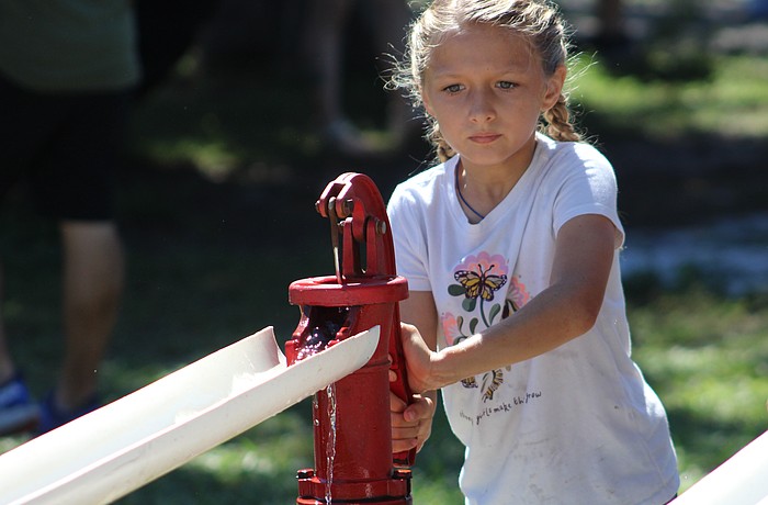 Lakewood Ranch's Jenna Ziegler works quickly to move as much water as she can with a hand pump at the Dakin Harvest Festival Oct. 12 in Myakka.