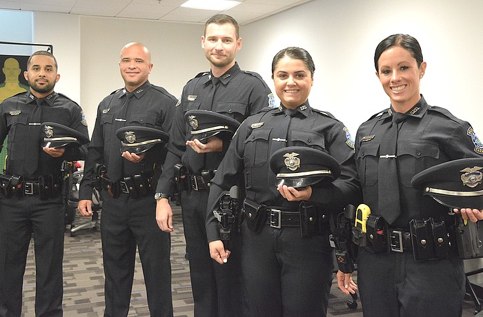 From left, newly sworn Sarasota Police Department officers Emilio Suriel, Gabriel Victorio, Tristan Sarney, Gabrielle Theofanous and Savannah Gray.