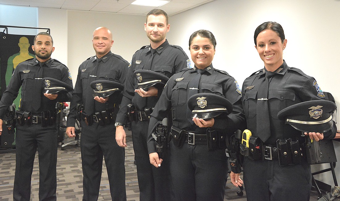 From left, newly sworn Sarasota Police Department officers Emilio Suriel, Gabriel Victorio, Tristan Sarney, Gabrielle Theofanous and Savannah Gray.