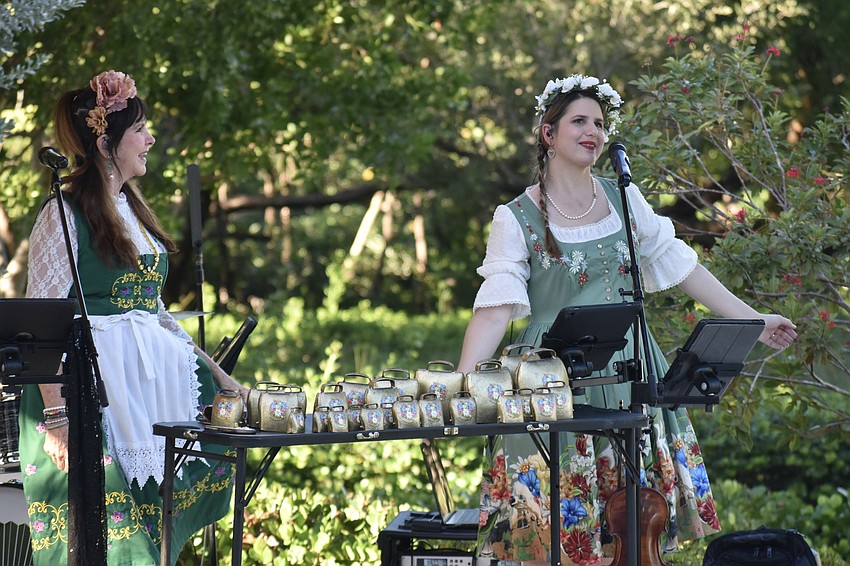 Sheila DeLeon and Haley DeLeon of the DeLeon Oktoberfest Band perform on stage.