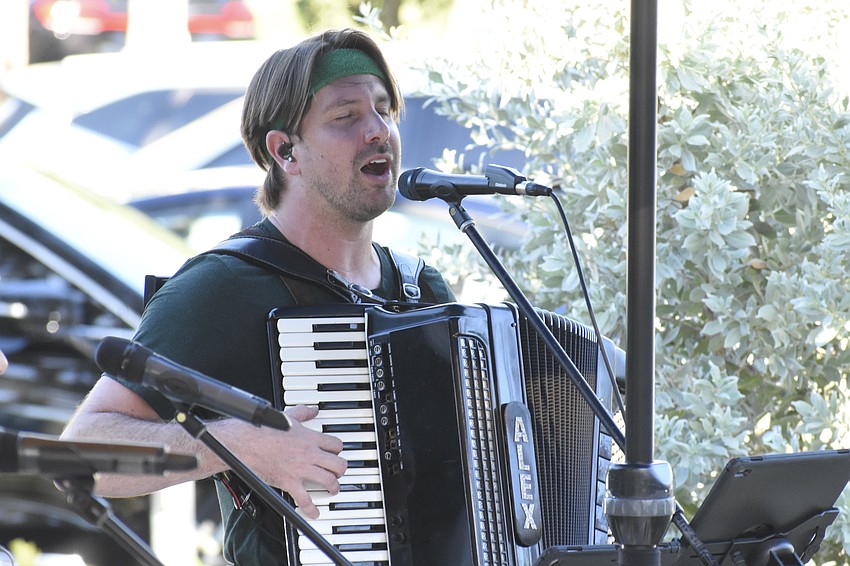 Alex DeLeon of the DeLeon Oktoberfest Band performs on stage.