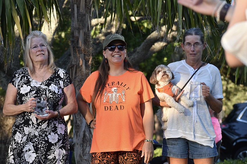 Donna Carey, Jennifer Boris and Michelle Kuelbs and her dog BonBon listen as the rules of the Steinholding contest are explained.