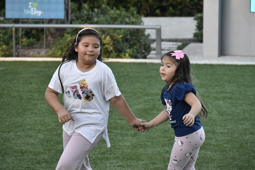 Ellie Portillo and her sister Ella Portillo dance to the live music.