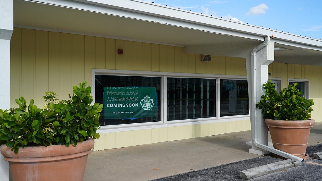 A banner announcing a new Starbucks location still sits inside the storefront of 3174 Gulf of Mexico Drive, but interior work is yet to begin.