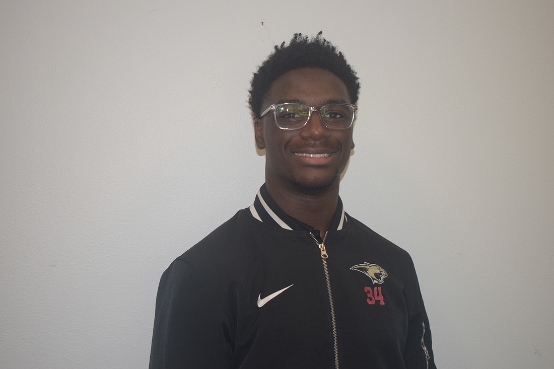 Connail Jackson poses for a photo on Oct. 14 at Cardinal Mooney Catholic High School. The junior running back paced the Cardinal Mooney offense last Friday, accounting for four of the Cougars' five touchdowns.