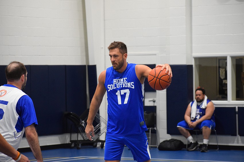 Wilcox dribbles the ball down the court as he nears the opponent's hoop.