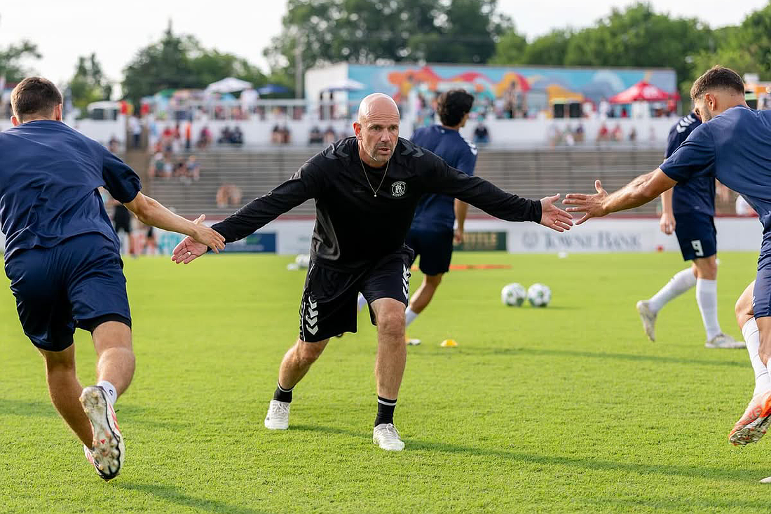 Mika Elovaara (center) high-fives two of his players during prematch warmups with the Richmond Kickers. The Oulu, Finland native and UNC Wilmington alumnus will guide the Paradise into USL League One in 2026.