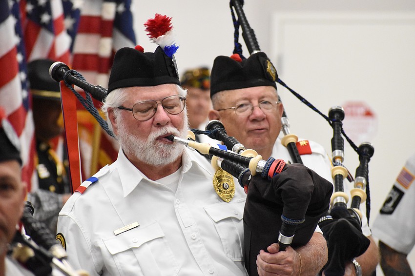 Pipers Ed Harder and Pat Johnston prepare to welcome the veterans.