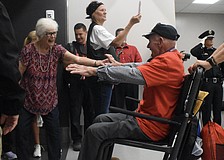 Nancy Manosh welcomes home her husband, Korean War veteran Carl Manosh, of Punta Gorda, whose guardian was Mike Semones, a Southwest Florida Honor Flight board member who lives in Sarasota.