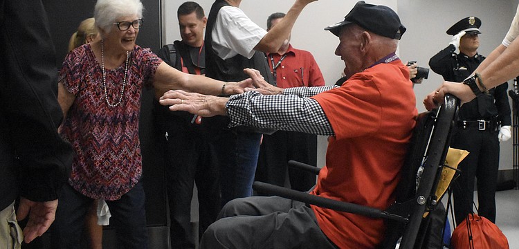Nancy Manosh welcomes home her husband, Korean War veteran Carl Manosh, of Punta Gorda, whose guardian was Mike Semones, a Southwest Florida Honor Flight board member who lives in Sarasota.