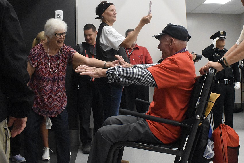 Nancy Manosh welcomes home her husband, Korean War veteran Carl Manosh, of Punta Gorda, whose guardian was Mike Semones, a Southwest Florida Honor Flight board member who lives in Sarasota.