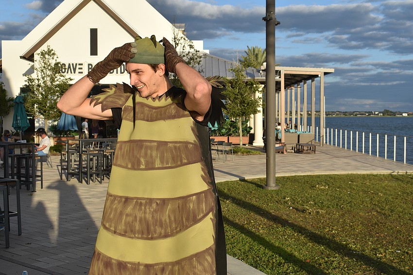 Zach Harris makes a quick change offstage into the Cheshire Cat costume.