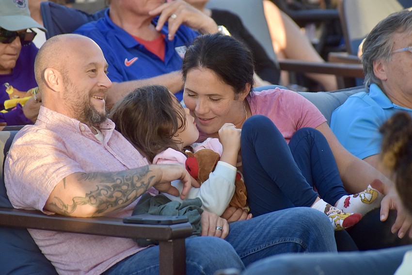 Lakewood Ranch's Brad, Emma and Cara Githens watch an adaptation of Alice in Wonderland at Waterside Place Oct. 17.