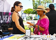 Patron Disha Webb tries on a ring crafted by artist Julia Bernadsky at last weekend's fine art festival on St. Armands Circle.