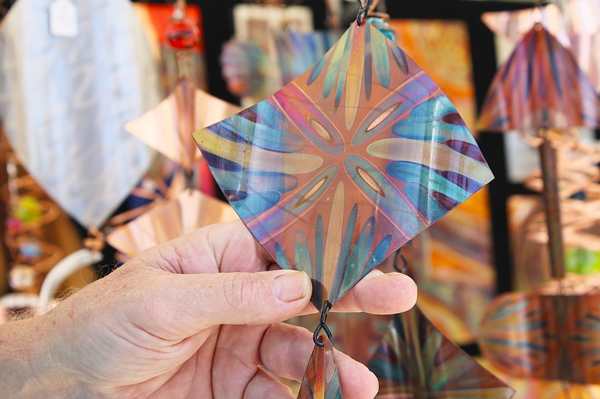 Metalwork artist Robert Boyce said it took some time to perfect the techniques he uses with flames to bring out the natural colors of the copper pieces he sold at the fine art festival on St. Armands Circle.
