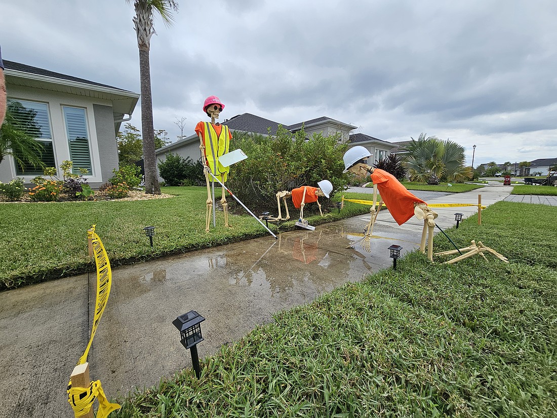 Residents at a home on Mosaic Boulevard display a blind skeleton crew working on the sidewalks. Photo by Sierra Williams