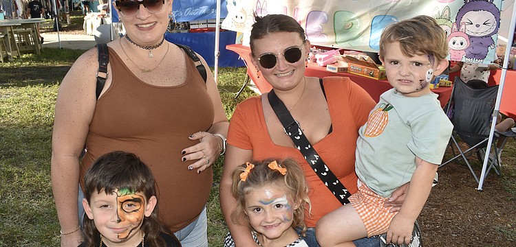 Noah Roman, 5, his mother Kiersten Perez,  Salem Friday, 4, her mother Tabitha Lenz, and brother Teddy Friday, 2, came dressed for the season.