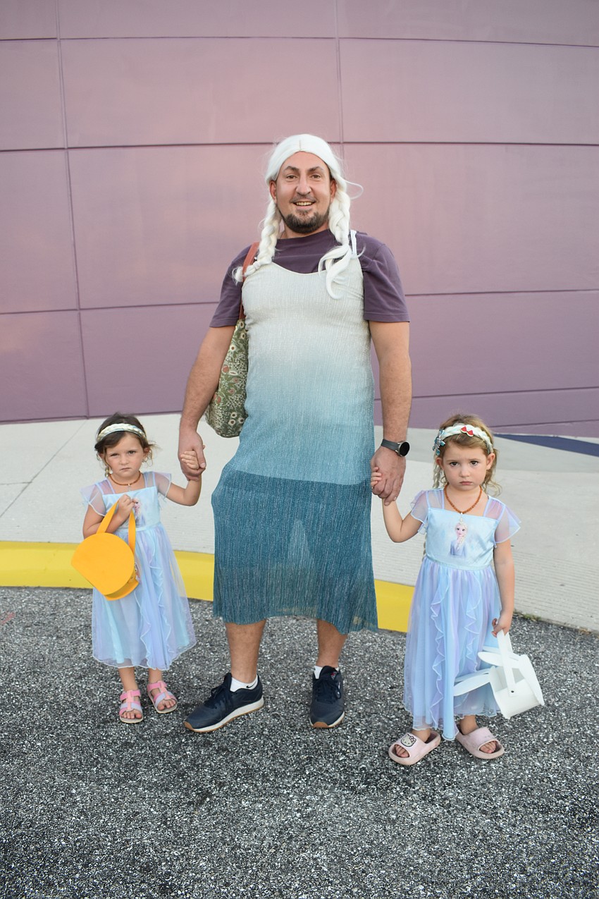 Anna Sinelnikov, 3, her father Dmitry Sinelnikov, and sister Mia Sinelnikov, 3, all dressed up together as Anna from 