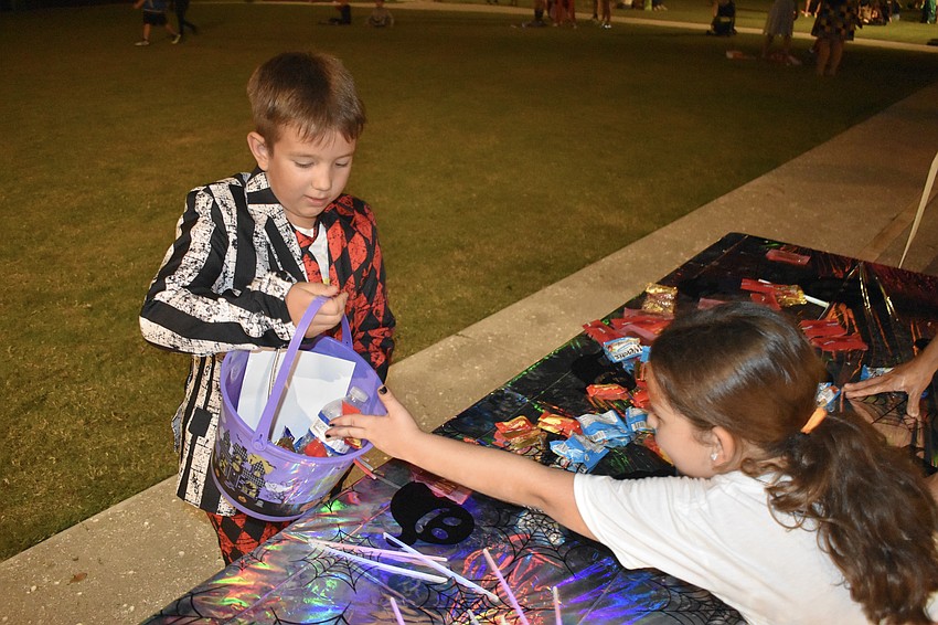 Sviatoslav Pavliuk, 9, accepts candy from Piper Borgia-Howard, 6.