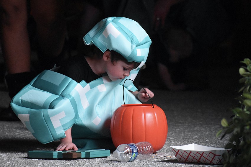 River McMichael, 5, looks over his treats as he watches 