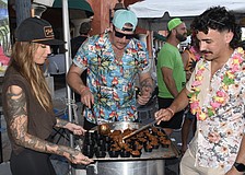 Tara Piedra, and Ariel Betancourt and Michael Matheis of Station 9, prepare chili.