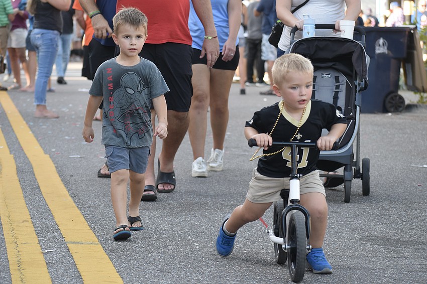 Sawyer Sines, 4, and Jack Foster, 2, make their way through the event.
