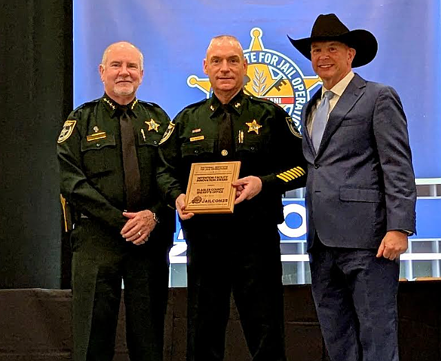 Sheriff Rick Staly (left) and Court and Detention Services Chief Dan Engert (center) accept the National Innovation Award from National Institute for Jail Operations Executive Director Tate McCotter (right). Courtesy photo