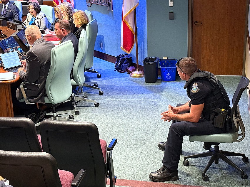 Sarasota City Commission meetings have long had officers seated next to the dais.