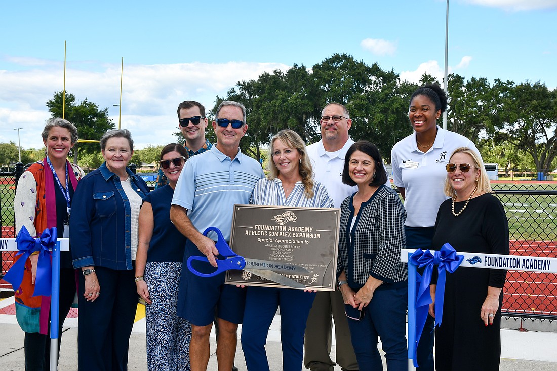 Foundation Academy’s staff gathered with donors to celebrate the ribbon cutting.