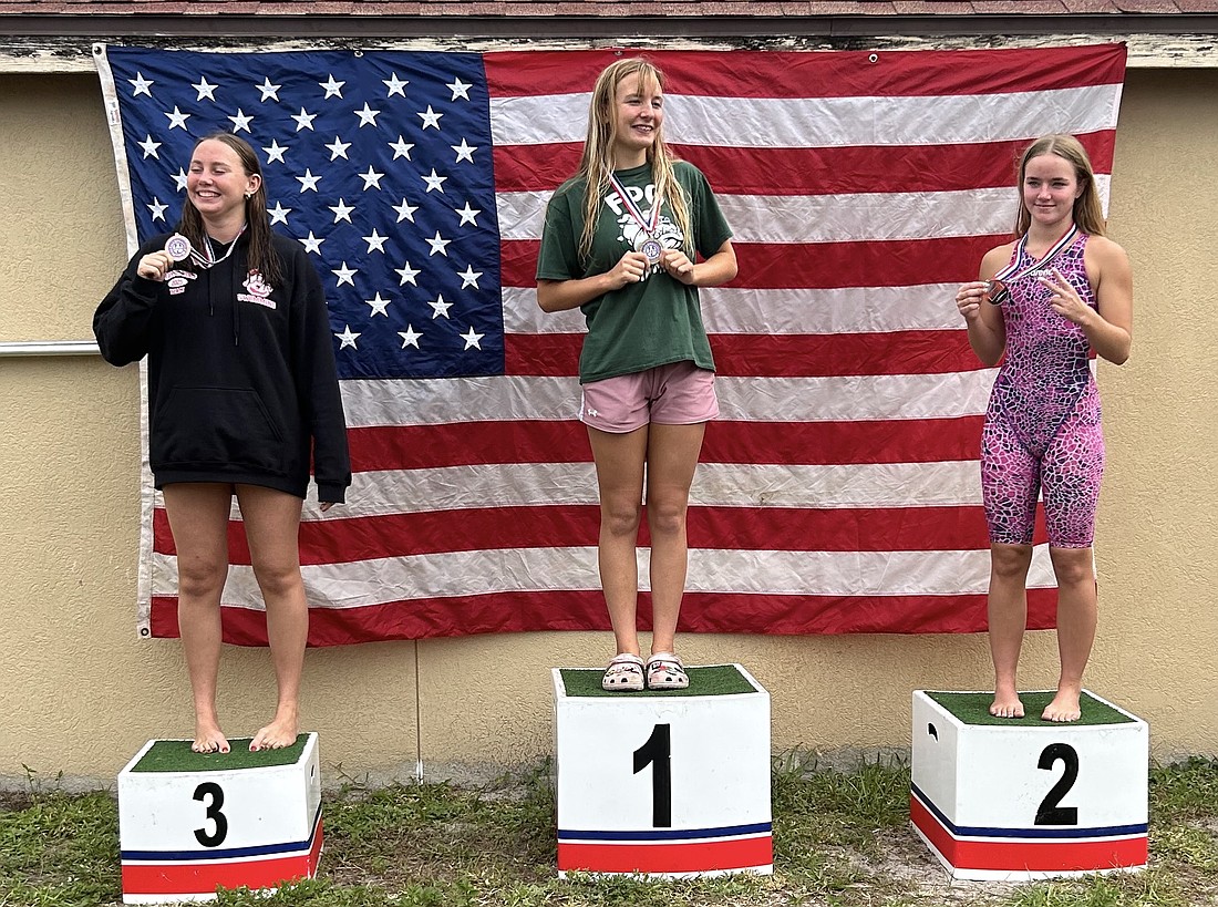 FPC's Emm Gilbert, center, won the 100-yard breaststroke at the Five Star Conference swim championships. Courtesy photo