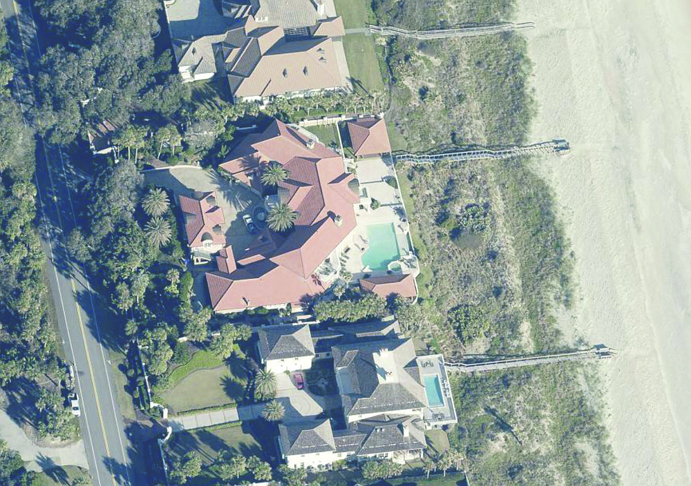 Oceanfront home features 11 bedrooms, 13 full and three half-bathrooms, office, gym, sauna, steam room, theater, wine cellar, gazebo, porches, guesthouse, outdoor kitchen, pool, 10-car garage and dune walkover.