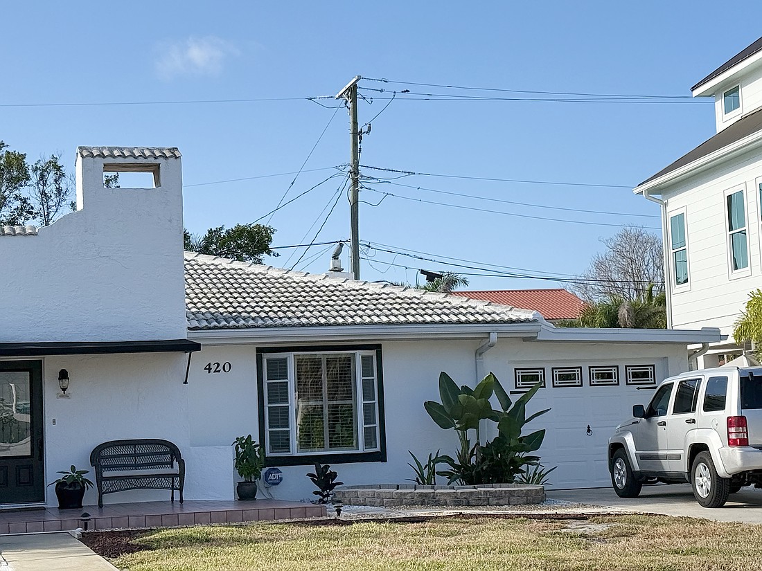 Utility lines are strung along rear yards on some streets on Lido Key.