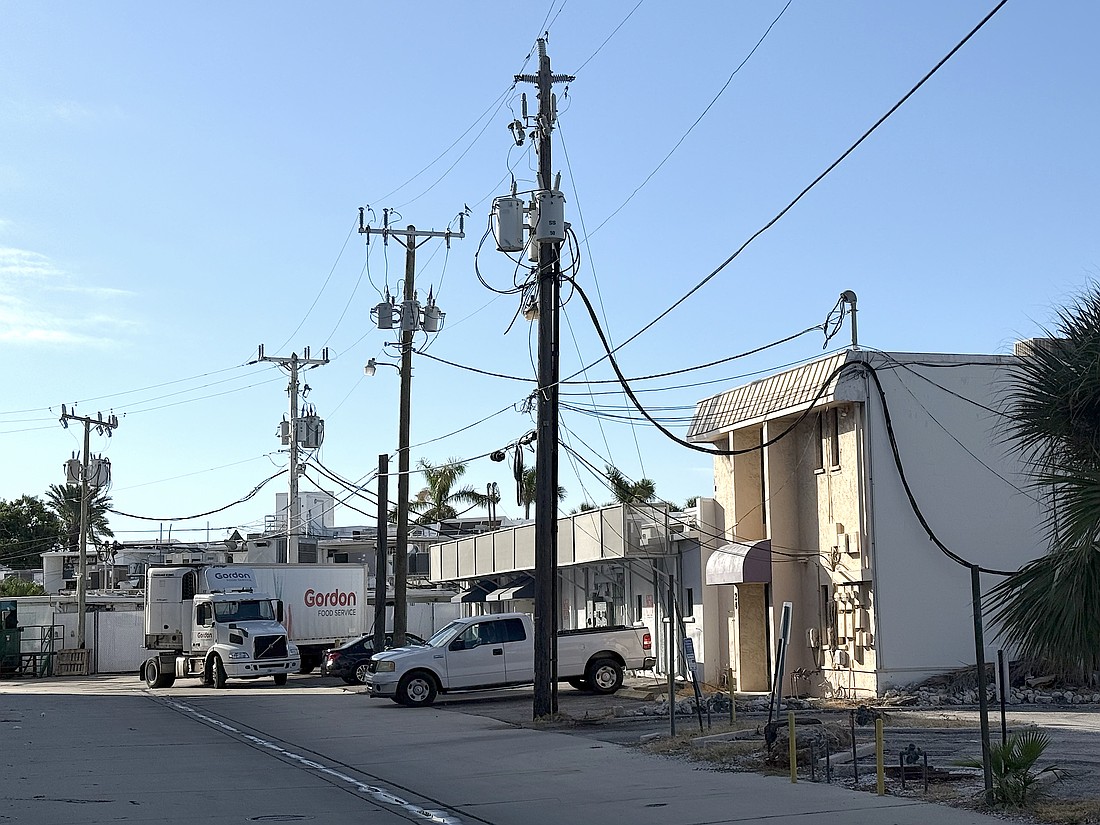 Overhead utility lines behind commercial buildings on St. Armands Circle.